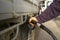 man filling up his 4WD car with fuel from a black petrol bowser, rural New South Wales