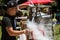 Man Fills Pitcher With Liquid Nitrogen At Ice Cream Festival