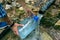 A man fills a plastic bottle with water from an underground source of clean water