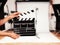 Man with film clapper in studio