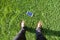The man find mobile phone on grass. top view of human foot and mobile phone on grass.