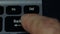 Man finger pressing backspace button of notebook computer keyboard