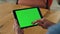 Man finger swiping greenscreen tablet office. Close up specialist scrolling tab