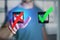 Man finger touching a hand drawn red and green tick icon on a futuristic interface - technology concept