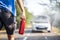 Man with a fire extinguisher helping a person with a car in the