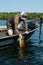 Man Fishing in Boat Landing a Trophy Smallmouth Bass