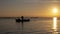 Man fishing in a boat at sunset in Albufera of Valencia