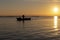 Man fishing in a boat at sunset in Albufera of Valencia