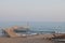 A man is fishing with a fishing rod near a rocky shore. Fisherman on the beach in Alanya. Fishman stands on the rocks in