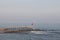 A man is fishing with a fishing rod near a rocky shore. Fisherman on the beach in Alanya. Fishman stands on the rocks in