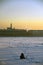 A man fishing on a frozen Neva river in historical city center of Saint-Petersburg