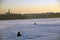 A man fishing on a frozen Neva river in historical city center of Saint-Petersburg