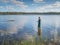 Man fishing in a lake. Ecotourism, visiting fragile, pristine, undisturbed natural areas