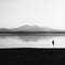 A man is fishing in the lake at sunset. Wetland and mountain landscape