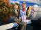 Man Fishing Large Mouth Largemouth Bass in Fall