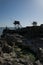 Man fishing next to traditional French fishing huts in Saint-Palais-sur-Mer