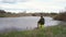 a man fishing in a pond sitting on a chair