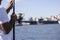 Man fishing on sea coast. Focused on fishing reel. In the background is the galata wicked and seascape