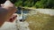 A man is fishing in a small mountain river, catches a carnivorous fish by spinning a spoon-bait