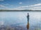 Man fishing with spinning in a lake. Ecotourism, visiting fragile, pristine, undisturbed natural