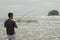 Man fishing in the surf on Rockaway beach