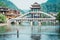 Man fishing on water at the river Tuojiang in the Ancient city of China, Fenghuang. Traditional Chinese bridge. Village of the