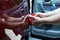 Man fixing car dent by himself