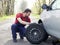 Man fixing a car problem after vehicle breakdown