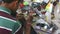 Man fixing electrical components with a specialized tool in workshop in Mumbai.