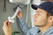 Man fixing pipes under sink