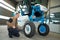 Man fixing tractor in agro-industrial hardware