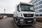 MAN flatbed truck stands on roadside