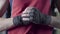 Man flexing his fists before a fight. Close-up of a young Thai boxer hands hemp ropes are wrapped before the fight or