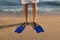 Man in flippers on sandy beach, closeup