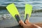 Man in flippers on sandy beach, closeup