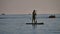 Man is floating while standing in ocean paddle board. by the sea on a boat. Holiday on the Black Sea