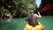 man floats kayak and looks around kayak