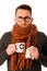 Man with flu and fever wrapped in scarf holding cup of healing t