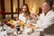 Man in a fluffy bathrobe pours coffee for his wife