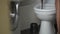 man flushes after himself in the toilet and leaves