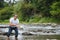 Man fly fishing casts on Irish river