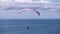 A man fly a paraglider over the dunes of Cape Kiwanda.