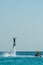 Man on flyboard above the azure sea. Water sport adventure