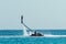 Man flyboarding above the crystal sea. Water sports adventure