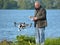 Man flying Drone, Drone in picture, water in background.