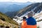 Man flying a drone in the mountains. Pip Ivan peak. Sunny cloudy day in summer, Marmarosy ridge,