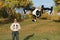 Man Flying A High-Tech Camera Drone (Fall Trees & Leaves in Background)