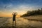 man flying a kite on the beach, people learning kitesurfing