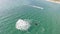 Man flying over sea on flyboard. Aerial view from copter.