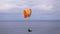 A man flying a paraglider over Cape Kiwanda State Natural area